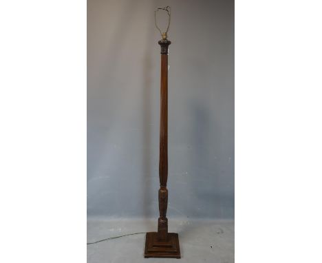 An Edwardian inlaid mahogany standard lamp, with carved floral decoration, having urn and flower marquetry inlay, on stepped 