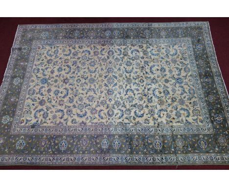 A Central Persian Najabafad carpet, all over floral motifs on an ivory field, guarded by a stylised jade floral border, 370 x