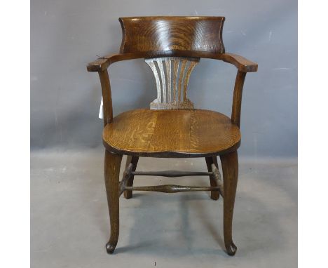 An early 20th century oak captains desk chair 