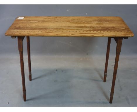 A vintage pine draftsman table raised on folding legs, H.66 W.93 D.49cm 