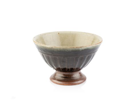 Richard Batterham (1936-2021)Tazzastoneware, green ash glaze to interior, tenmoku to exterior9.5cm high x 13.5cm diameter.  C