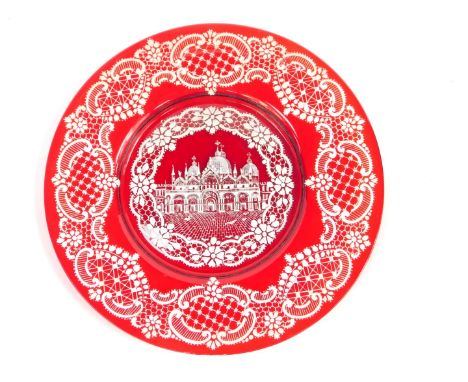 A Venetian ruby glass dish, enamel decorated with St Marks Duomo Venice, within floral and rococo scroll borders, 25.5cm wide