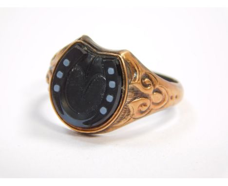 A Victorian gentleman's 9ct gold and black onyx horseshoe ring, size T, Birmingham 1886, 2.7g.