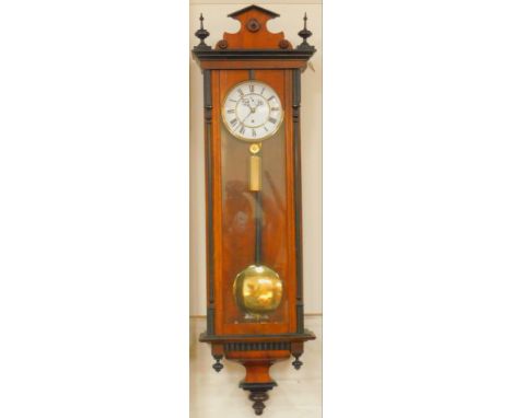 A late 19thC Continental walnut and ebonised Vienna wall clock, circular enamel dial bearing Roman numerals, subsidiary secon