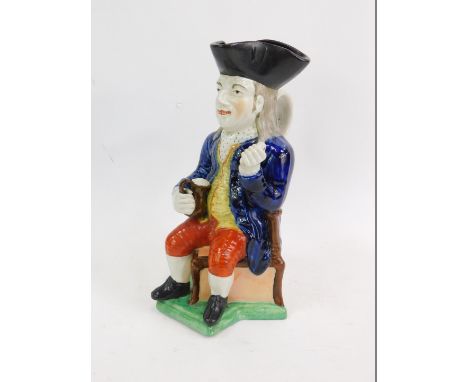 An early 19thC pearlware character jug modelled as The Squire, pipe lacking, 28cm H.