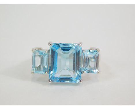 A silver blue and white topaz three stone ring, the square and baguette cut stones in a stepped, claw setting, 2.15cts, size 