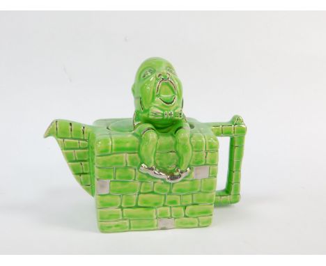 A Lingard pottery teapot modelled as Humpty Dumpty, sitting on the wall, green and silver lustre glaze, RD830.104, printed an