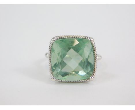 A silver and Tucson teal green fluorite ring, the cushion shaped fluorite in a high claw setting, 14.21cts, size L/M, with ce