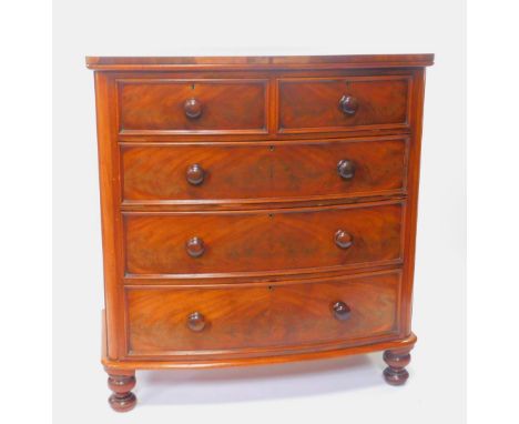 A Victorian mahogany bow front chest, of two short over three long drawers raised on turned feet, 120.5cm H, 114cm W, 55cm D.