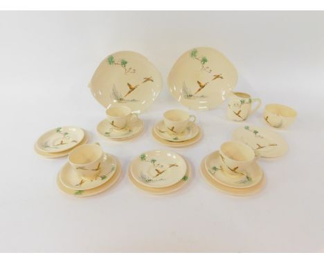 A Royal Doulton pottery part tea service decorated in the Coppice pattern, D5803, comprising a pair of bread plates, cream ju