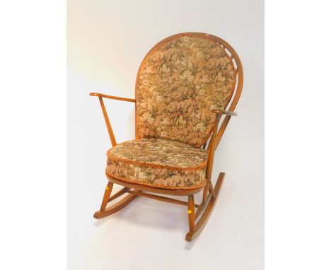 An Ercol beech and elm dark stained Windsor rocking chair, with a loose cushion seat and back.