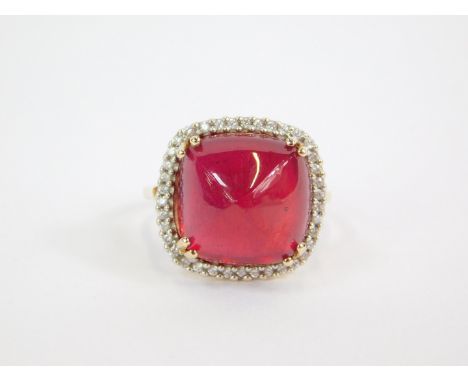 A 9ct gold Malagasy ruby and zircon Tomas Rae ring, the cushion shaped ruby in a surround of diamonds, size R/S, 2.12g gold, 