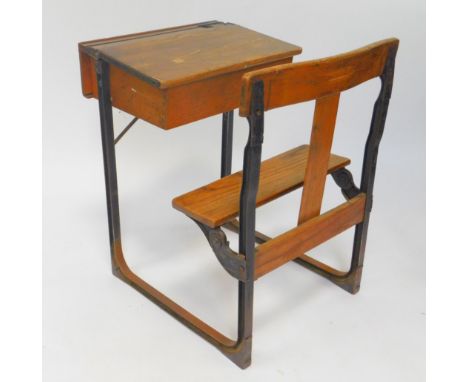 A Victorian oak and cast iron school desk, with integral seat, 88cm High, 61cm Wide, 77cm Deep.