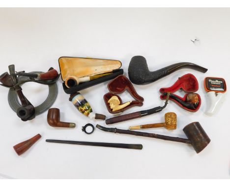 A group of 19thC wooden meerschaum and other pipes, variously carved and decorated, together with a pipe stand, some cased. (