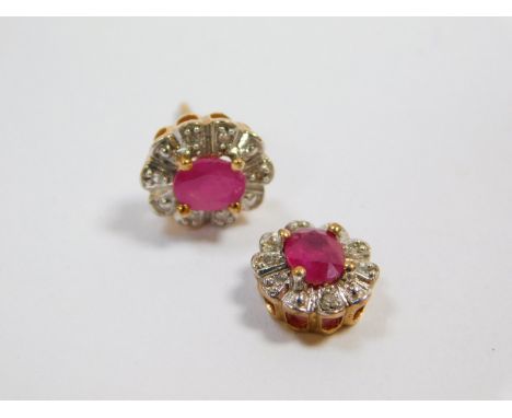 A pair of 9ct gold ruby and diamond set flower head earrings, the rubies oval cut, pin broken and lacking to one earring, 1.6