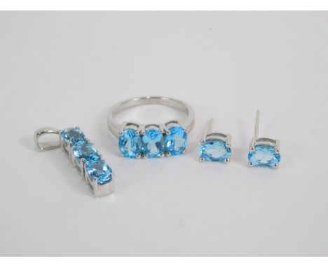 A silver and Swiss blue topaz set of jewellery, comprising three stone ring, size O, pair of solitaire earrings, and a three 