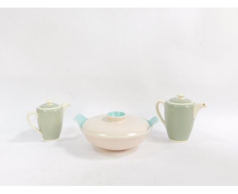 A Poole twin tone pottery vegetable tureen and cover, together with a pair of graduated green hot water jugs and covers. (3)