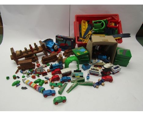 A collection of assorted toy trains and track including Tomy, Thomas the Tank Engine, wooden toys, etc 