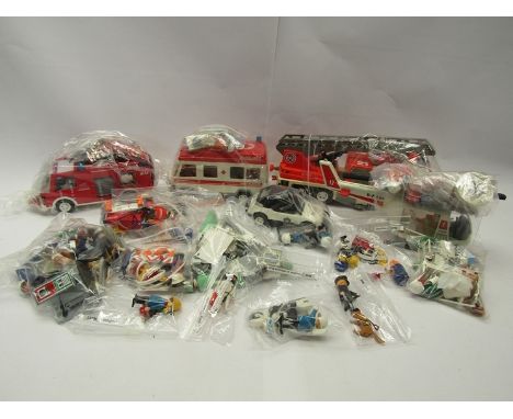 A collection of unboxed Playmobil emergency services figures, vehicles and accessories to include 3880 Rescue Unit 26, 3789 R