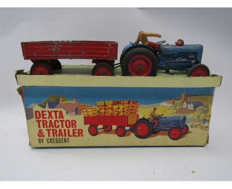 A boxed play worn Crescent diecast Dexta Tractor and Trailer 
