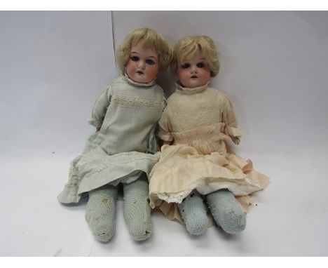 A pair of early 20th Century Armand Marseille 370 bisque head dolls in original pink and blue dresses and petticoats, each ap