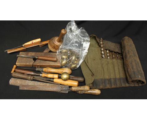 A collection of antique woodworking tools and a collection of brass doorknobs.