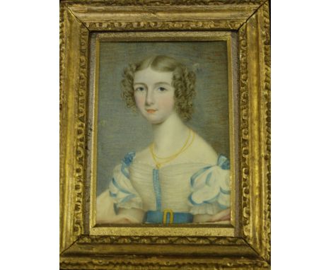 A Regency portrait miniature of a young lady, painted on ivory, the young lady with ringlets in her hair, wearing a gold neck