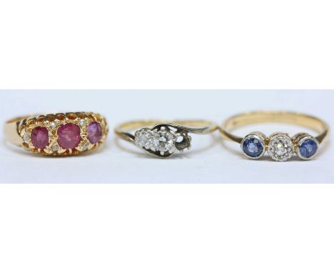 An 18ct gold, ruby and diamond ring, 18ct gold three-stone diamond ring (one stone missing), and an 18ct and platinum sapphir