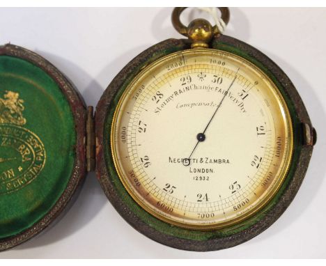 A Victorian brass pocket barometer by Negretti & Zambra of London, number 12932, with silvered dial, in a fitted leather case