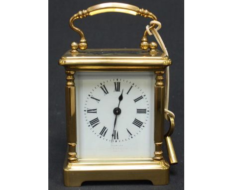 An early 20th century French gilt brass carriage clock, the white enamel dial with black Roman numerals, signed indistinctly.