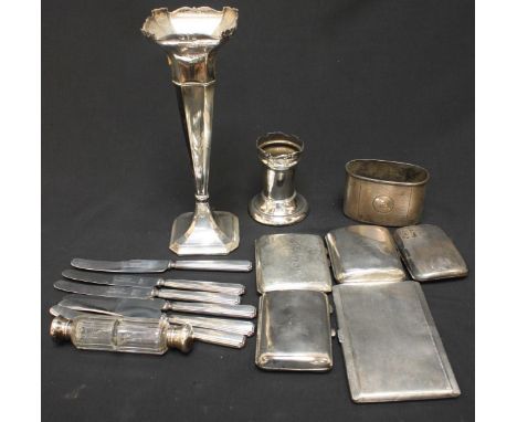 A collection of assorted silver items including five cigarette cases, an Asprey hip flask cup, a flared spill vase, a spill v