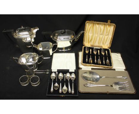 A collection of silver plated items including a four piece tea service, three sets of cased flatware, and napkin rings.