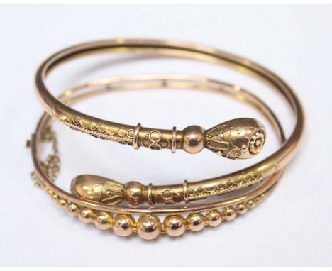 A 9ct gold bangle (5.1 grams), and a yellow metal bangle with applied wirework decoration, unmarked, (10.3 grams). (2)
