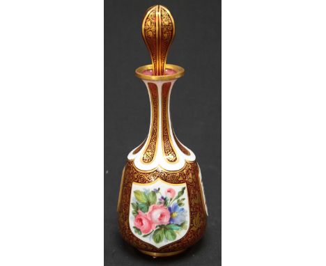 A 19th century Bohemian cranberry glass bottle and stopper, painted with a shield shaped portrait of a young girl with bird, 