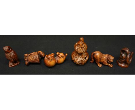 A collection of six Chinese carved boxwood netsuke, including a tiger, an owl, a frog, two frogs on a gourd, a snake and a be