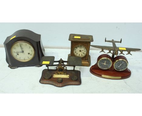 A small tin clock together with a Smiths Bakelite mantel clock, a set of postal scales and a novelty combined clock and barom