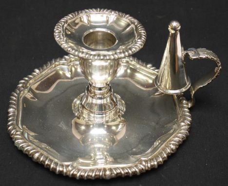 An Elizabeth II silver chamber stick, hallmarked Birmingham 1972, with shaped gadrooned rims, and snuffer. 9.2 oz..