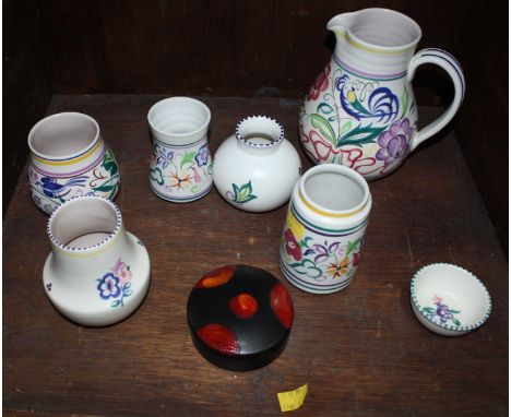 SECTION 44.  Seven floral-painted cream Poole Pottery pieces including a large jug, and a Delphis pattern circular pot and co