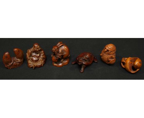 A collection of six Chinese carved boxwood netsuke, including a rabbit, two carp, tortoise on a barrel, a tortoise, and a sea