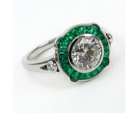 Approx. 1.10 Carat Round Brilliant Cut Diamond, .63 Carat Calibre Cut Emerald and Platinum Ring. Diamond H color, VS clarity.