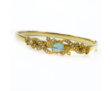 Vintage 14 Karat Yellow Gold Bangle Bracelet set with an Oval Cut Opal and Seed pearls. Stamped 14. Good vintage condition. M