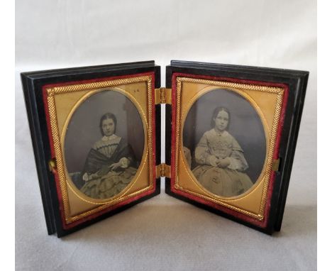 A fine Whitby jet cased Victorian&nbsp;Ambrotype, the two oval portraits of young lady's are hand tinted with gilt metal moun