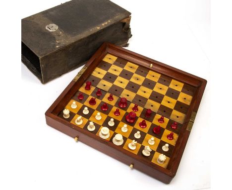 Jaques cased bone chess setin a mahogany folding case/board, and with a cloth outer case, the edge marked 'In Statu Quo, Pate