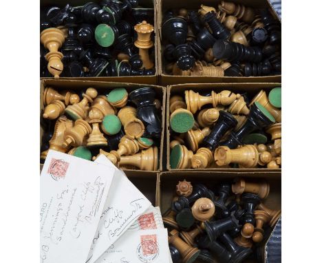 Three Staunton chess setseach in a cardboard box, a collection of spare pieces, and a collection of chess related postcards c