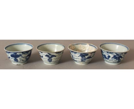 A SIMILAR GROUP OF FOUR CHINESE KANGXI PERIOD SHIPWRECK BLUE & WHITE PORCELAIN TEABOWLS. (4)