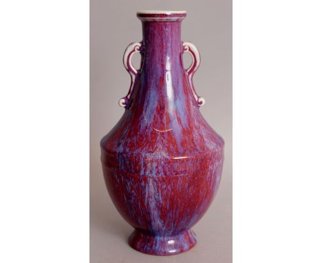 A CHINESE FLAMBE GLAZED PORCELAIN VASE, the sides applied with a streaked red and purple glaze, the base with an underglaze i