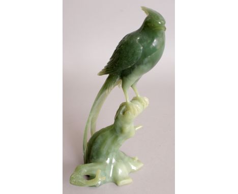 A 20TH CENTURY CHINESE CELADON GREEN JADE CARVING OF A GOLDEN PHEASANT, together with a fitted box, the bird perched on rockw