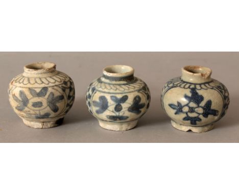 A GROUP OF THREE CHINESE WANLI PERIOD SHIPWRECK BLUE & WHITE PORCELAIN JARLETS, each painted with two floral panels reserved 