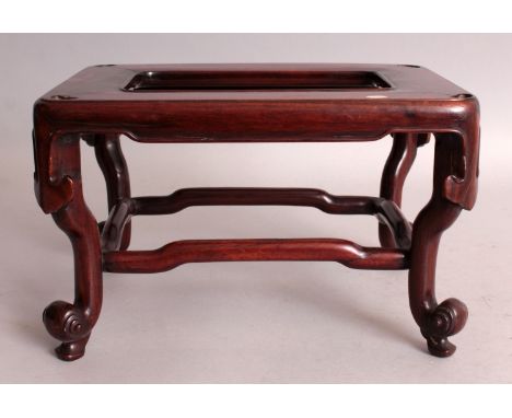 A GOOD QUALITY 19TH CENTURY CHINESE CARVED HARDWOOD RECTANGULAR STAND, supported on scroll end feet beneath dependent ruyi, 1