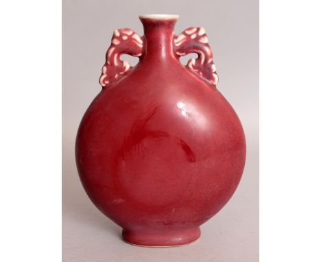 A CHINESE RED GLAZED PORCELAIN MOON FLASK, 6.1in wide at widest point & 8.1in high.